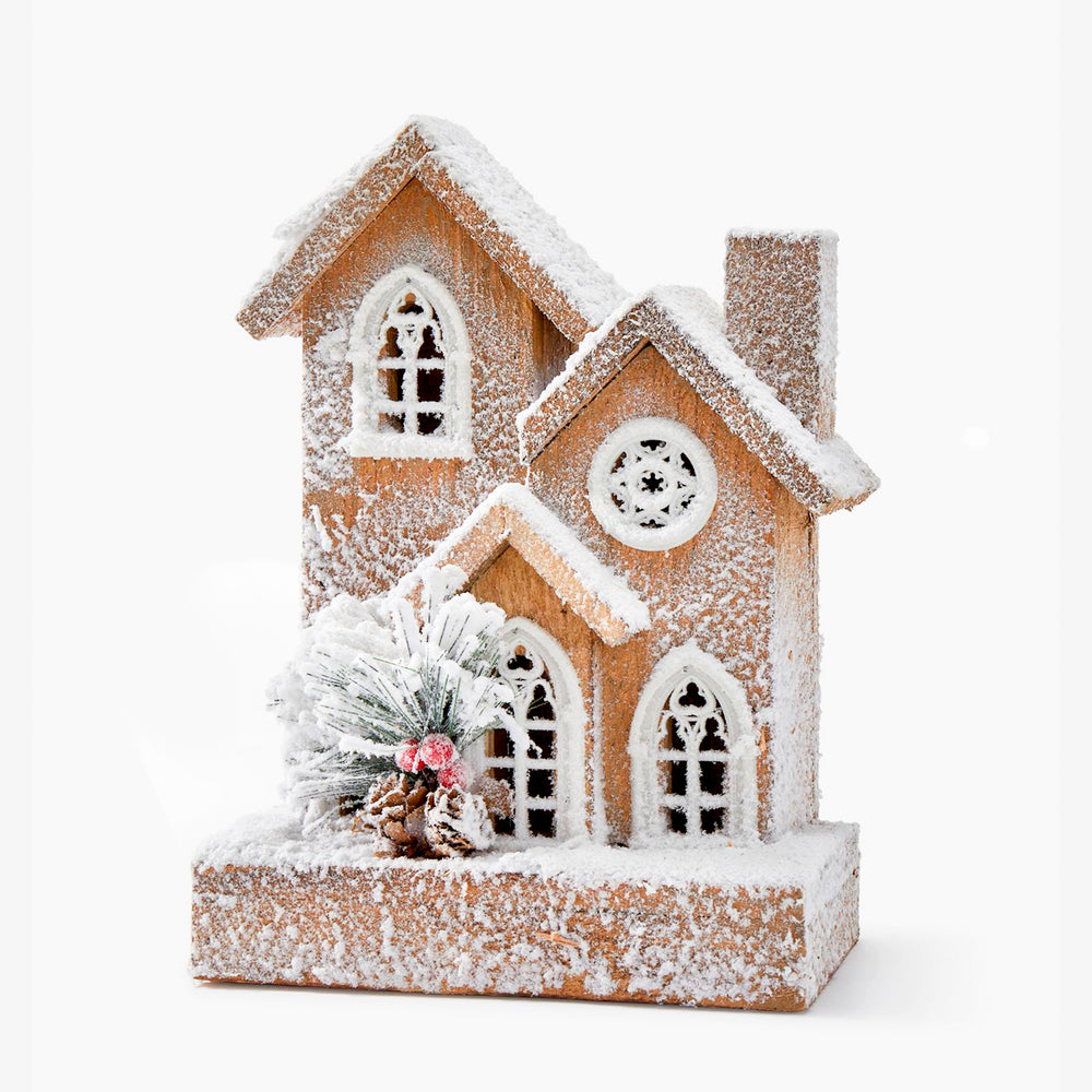Snowy and illuminated wooden house