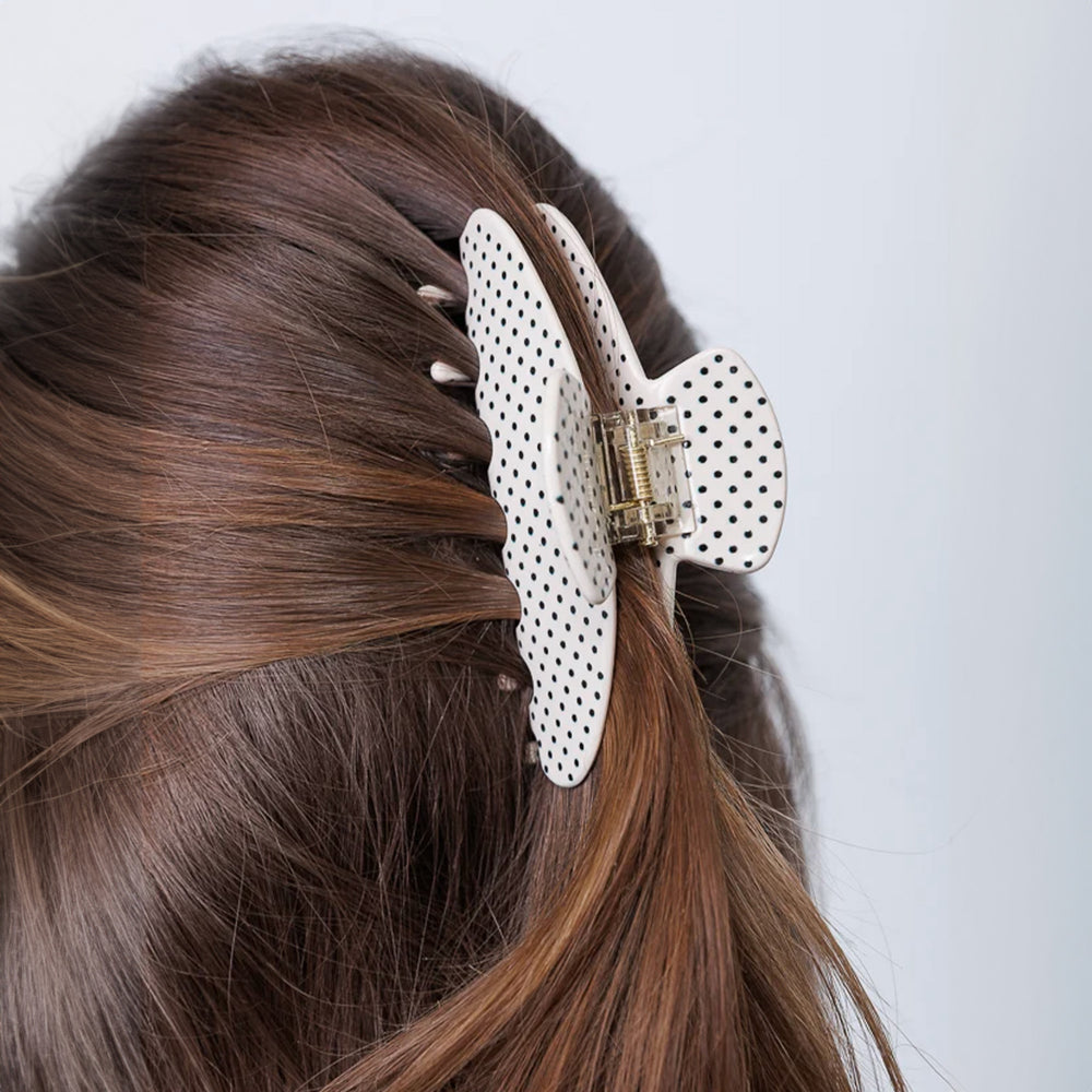 White hair clip with black polka dots